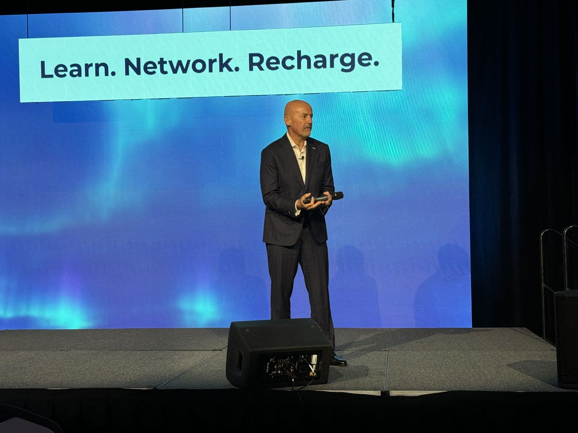 Steve Lowisz delivering a keynote presentation on stage