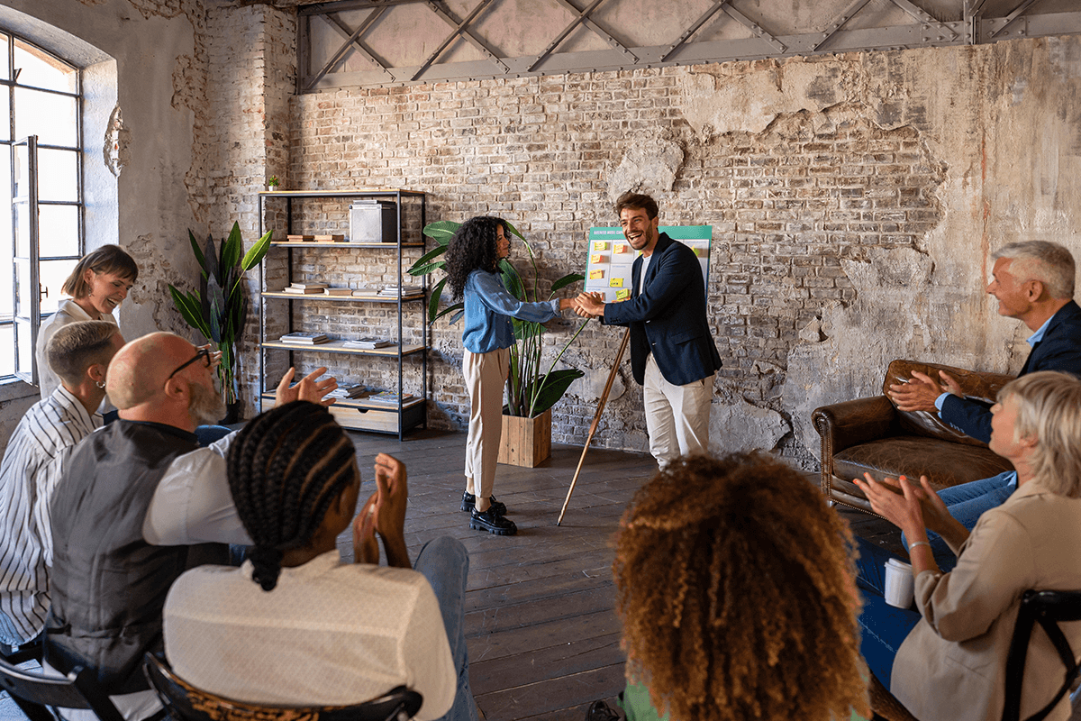 Leadership workshop with team members celebrating a successful presentation