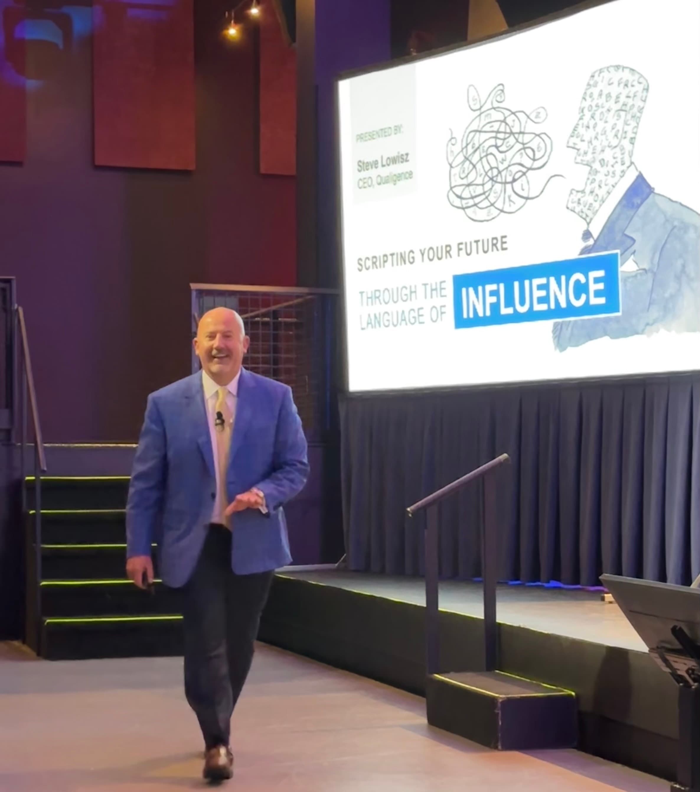 Steve Lowisz on stage presenting on leadership influence